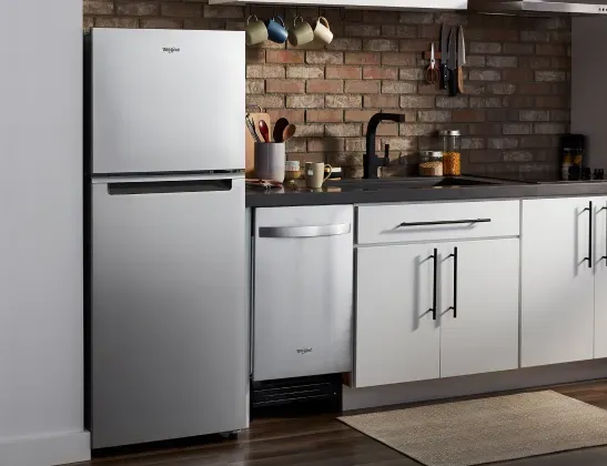 Whirlpool top mount fridge in brick kitchen, demonstrating reliability and value.
